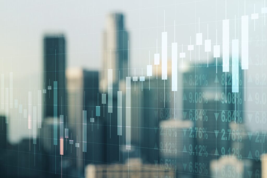 Abstract financial chart with candlestick patterns over a blurred city skyline, symbolising trade finance, market trends, and economic growth.